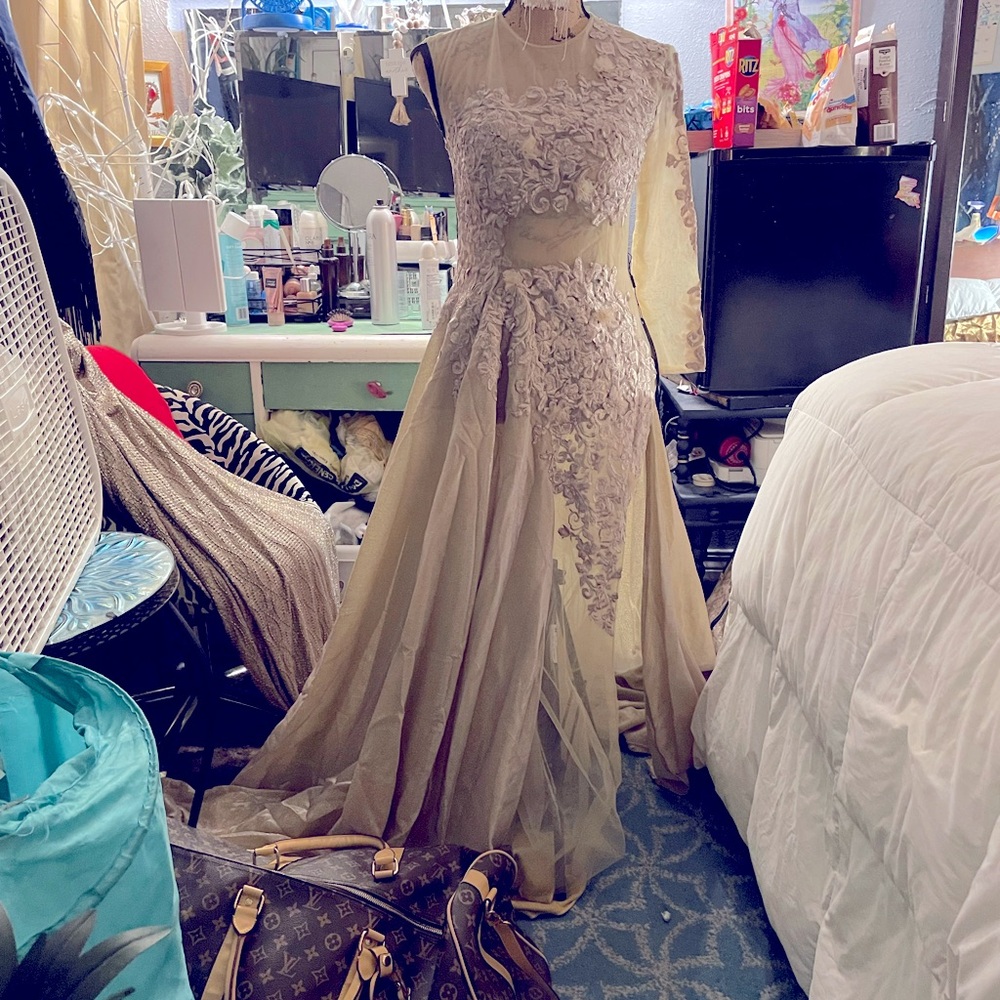 This gold dress still has tags on it